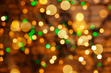 Fototapeta premium Defocused gold lights. Abstract holiday background. Beautiful shiny Xmas lights. Glowing magic bokeh. Defocused lights background. Twinkle lights bokeh. Blurred Christmas sparkles. Holidays