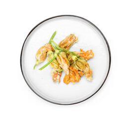 Plate with fried zucchini flowers on white background