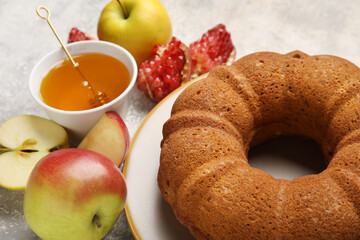Bread with honey and fruits on grunge background. Rosh hashanah (Jewish New Year) celebration