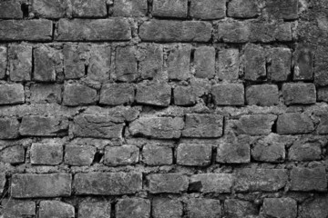 An old brick wall with patters as an Abstract in black and white
