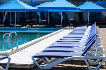 Sun loungers near swimming pool at sea resort