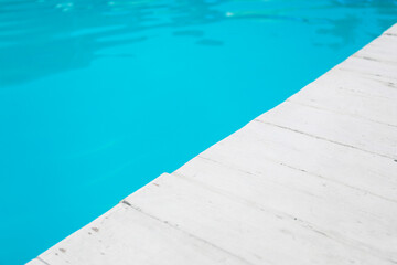 Fototapeta na wymiar Edge of swimming pool at sea resort, closeup