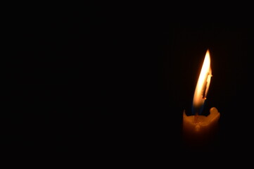 Fototapeta premium a burning candle in the dark