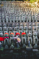 Lots of little 'Jizo' stone statues (representation of guardians of little dead kids) and flowers...