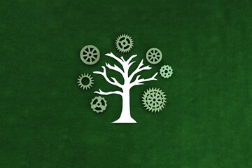 Tree, wooden gears on a green background. Joint business project, movement.