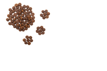 Dry food for dogs and cats in the shape of a footprint isolated on white background. Food for cats and dogs. Healthy pet food concept.