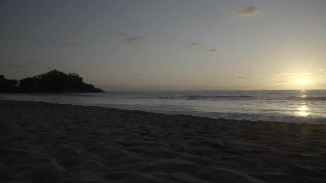 Sunset over the beach and waves of San Pancho, Mexico -Wide