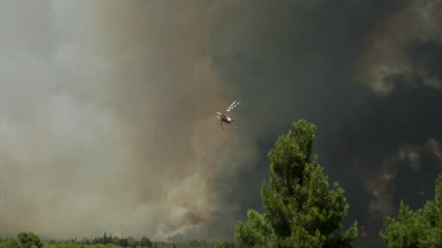 Big fire at Varimbombi, Athens, Greece, August 03, 2021. Fire fighting aerial means operate one hugger black smoke 120fps