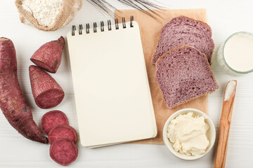 Top View Composition of Slice Homemade Purple Bread Made from Japanese Purple Sweet Potato with natural Color. Concept for Healthy Diet Bakery, Copy Space for Text or Recipe on White Background