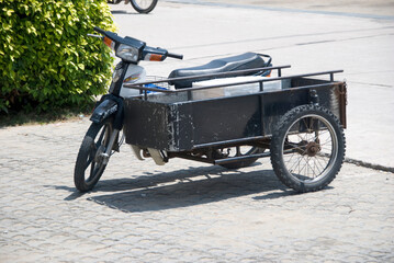 Typical asian sidecar moped parked