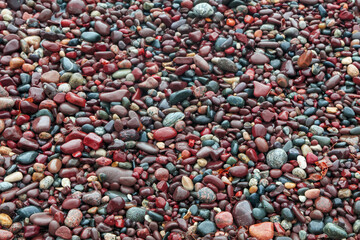Colorful small pebbles at Lake Superior shore line formed by waves in Michigan