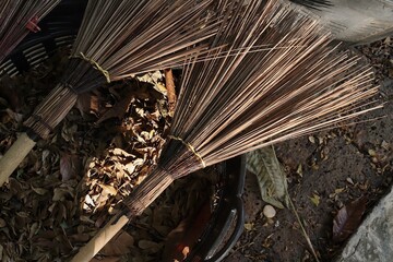 Sweeping dry leaves with broom being swept up clean concepts