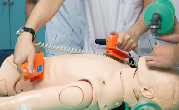 mannequin dummy during medical training to control of the defibrillate dummy. concept of saving lives