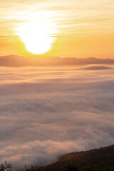 Fototapeta na wymiar sunrise or sunset with mist and mountain. Orange sky.