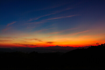 sunrise or sunset with mountain. Orange and blue sky background.