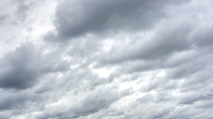 Many dense rain clouds in the overcast sky before the moment of the rain.