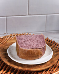 Homemade Purple  Bread Made from Japanese Purple Sweet Potato with natural Color. Served on White Plate White Background. Concept for Healthy Diet Bakery
