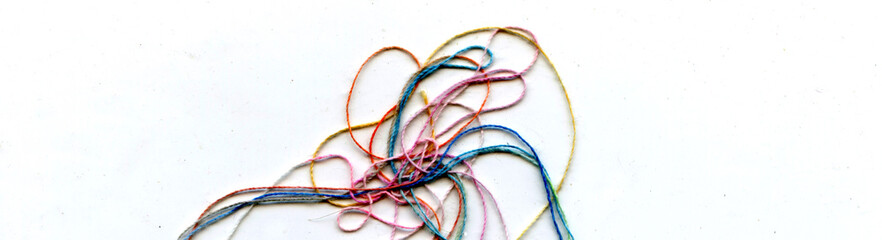 Multicolor tangled color needlecraft silk cord. Abstract color background, in white background