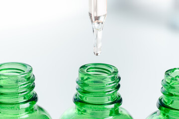 Dropper glass bottles with pipette. Transparent hyaluronic natural beauty product and eco serum skin care concept. Top horizontal view copyspace.