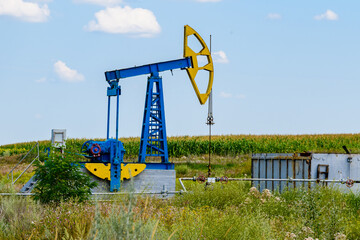 Fototapeta na wymiar Old pump jack at the field. Petroleum and gas industry