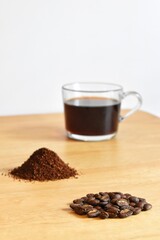 Ground coffee beans And black coffee in clear cup. The process of making coffee.