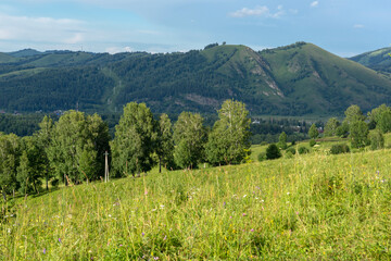 mountain valley with low mountains and blue sky