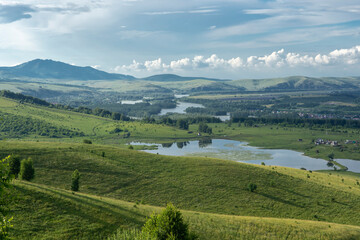 Obraz premium green trees and river in a mountain valley
