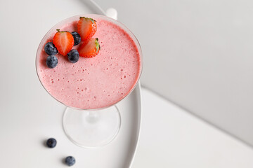 strawberry desserts mousse in glass with strawberry and blueberry on white table and white background
