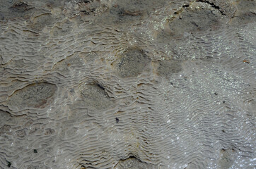 Pamukkale travertine texture. Wavy limestone textured deposits on terraces of carbonate minerals in...
