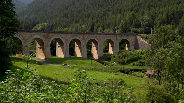Car driving through beautiful viaduct landscape at Semmering Railway in Austria