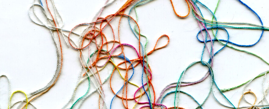Multicolor tangled color needlecraft silk cord. Abstract color background, in white background