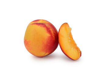 A whole ripe red-yellow nectarine next to a cut wedge. Isolated on white background