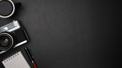 Top view retro camera, notebook and coffee cup on black leather with copy space.