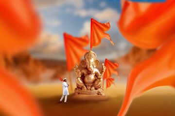 Golden lord ganesha sculpture with orange flag
