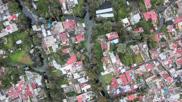 Jib up above a canal, houses and chinampas of Xochimilco, in Mexico City.