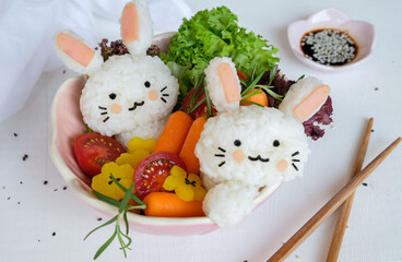 Delicious homemade Japanese cuisine. Rabbit Shaped Onigiri with Garden Salad. Healthy meal, decorated with family members for lunch or dinner.