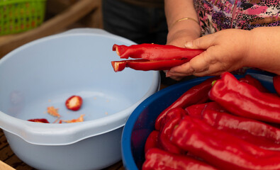 Mother and adult son drying red peppers together, a traditional Spanish Mediterranean cuisine