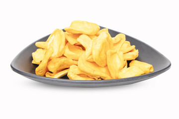 Dried jackfruit. Close up of a pile of dried jackfruit on a black plate for a snack chips. Food preservation concept popular in Thailand. Suitable for party. isolated on white background.