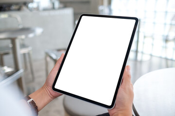 Mockup image of a woman holding digital tablet with blank white desktop screen