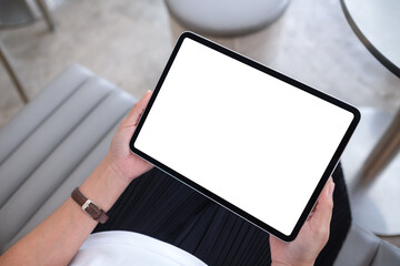 Top view mockup image of a woman holding digital tablet with blank white desktop screen