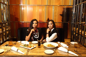 LGBTQIA+ two women have Lunch in restaurant on Dating. 20s young Lovely Friends feels happy smile