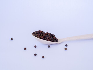 Fototapeta na wymiar black pepper on wooden spoon