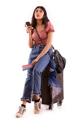 A young woman with an exhausted expression booking an online travel ticket on mobile phone.