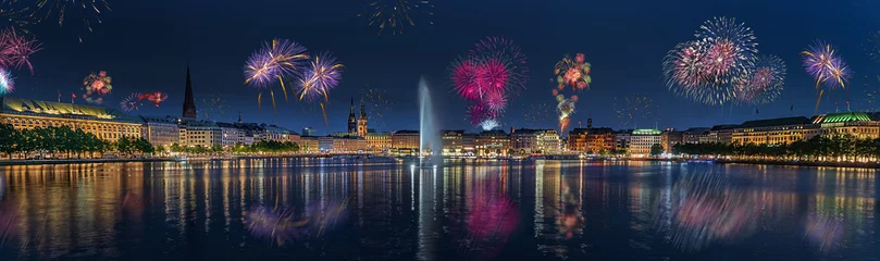 Panorama view of citycenter from Alster Lake,view to Hamburg Rathaus and fountain in the center of the lake with fireworks. Festive atmosphere with fireworks in Hamburg. Port birthday in Hamburg. © snapshotfreddy