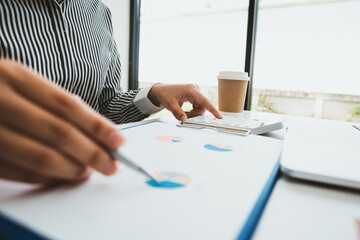 Business people or accountants are analyzing graphs on finance, investment, graph chart business strategy ideas, data analysis technology.