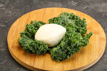 Soft mozzarella cheese over board