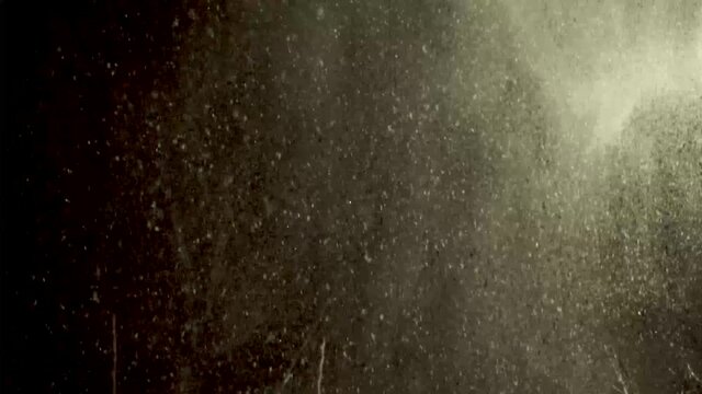 Swirls of snow drift in and out of view of the house light during this heavy winter storm late at night in this steady clip