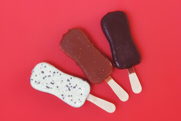 Three flavors ice cream set on pink background. Chocolate, coffee and milky coated set