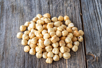 Roasted hazelnut. Hazelnuts on wood background. Bulk Hazelnut kernels