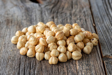 Roasted hazelnut. Hazelnuts on wood background. Bulk Hazelnut kernels